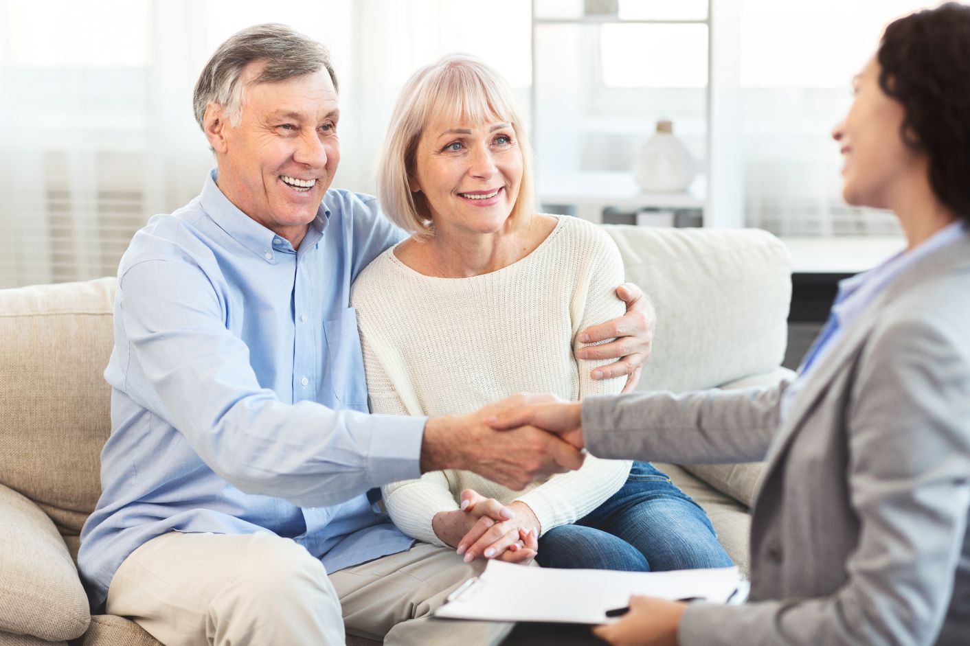 older couple at hearing aid fitting with audiologist